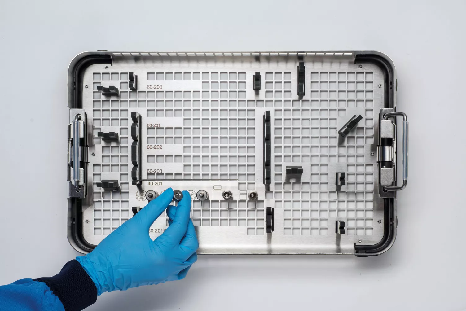 Hand met handschoen werkt met medische tray op tafel.